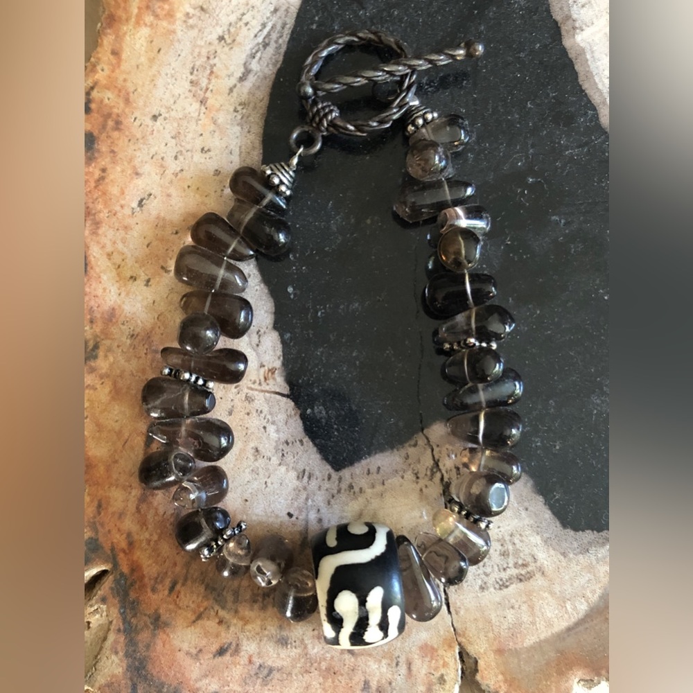 Brown variegated stone bracelet with unusual bead